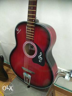 Red and black pure acoustic guitar, with 6 months