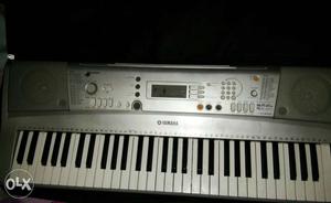 Silver And White Yamaha Electric Keyboard