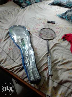 Black And Gray Badminton Racket With Vase