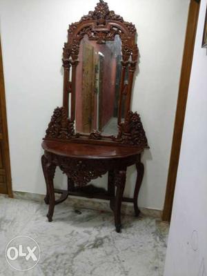 Intricately carved wooden table with mirror