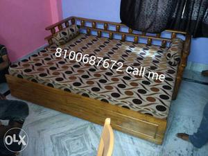 Brown Wooden Frame Bed With Polka Dot Mattress