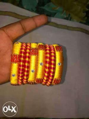 Eight Yellow And Red Silk Thread Bangles