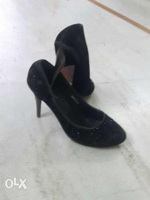 Pair Of Black Suede high heels shoes
