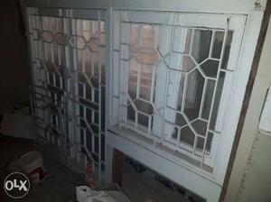 Patak wood window with metal grill. with window