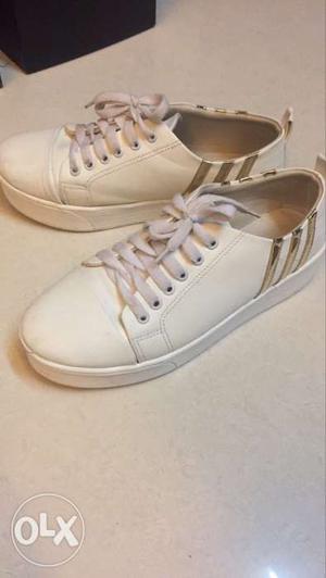 Person's Pair Of White Low Top Sneakers