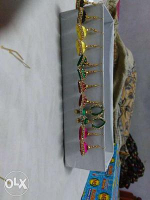 Six Pairs Of Green, Pink, And Yellow Jhumka Hook Earrings