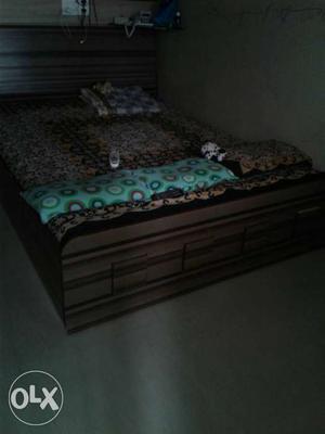 5ft by 6ft brown wooden bed with storage and