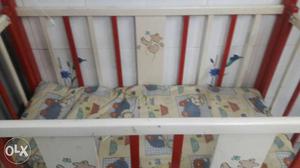 Baby's White And Red Wooden Crib