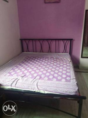 Black Metal Bed With White And Purple Floral Foam Mattress