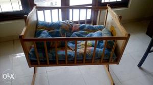 Brown Wooden Cradle With blue-pink-white Pad