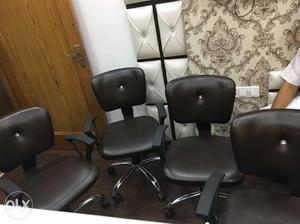 Four Black Leather Rolling Armchairs