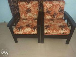 Two Black Wooden Framed Brown Fabric Chairs