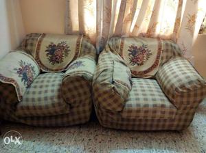 Two Brown Cushion Armchairs