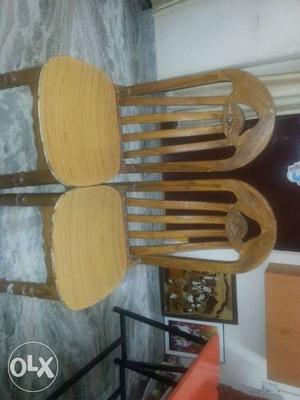 Two wooden dining table chairs.