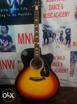 Black, Yellow And Red Cutaway Acoustic Guitar