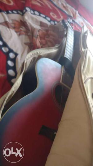 Red And Black Acoustic Guitar In Case
