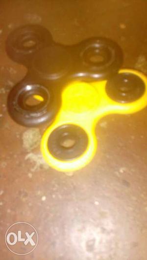 Two Black And Yellow fidget Spinners