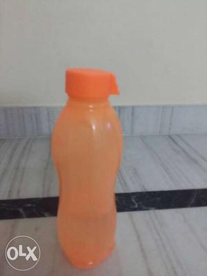 Orange colour brand new bottle with designer cap