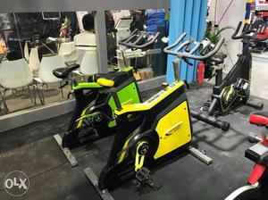 Two Green And Yellow Stationary Bikes