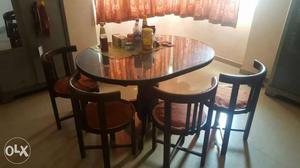 4 seating round wooden dining table with chairs