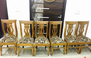 6 Brown Saagwan wood Chairs With Gray Floral Cushions