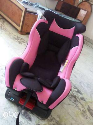 Baby's Pink And Black Car Seat