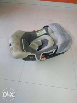 Baby's White And Gray Car Seat