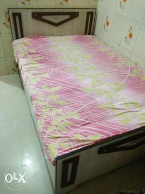 Bed with Pink And Yellow Floram Bedsheet