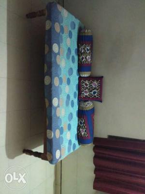 Cot with mattress and bolster pillows