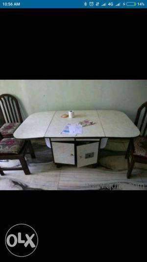 Dining table with 4 chairs. Table has folding top