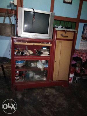 Gray CRT TV; Brown Wooden TV Stand With Cabinet