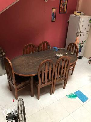 Oblong Brown Wooden Table With Six Padded Chairs