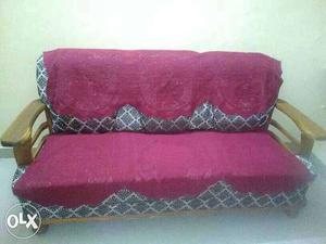 Pink, Gray, And Brown Suede Couch With Brown Wooden Frame