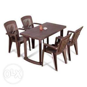 Reddish brown dining table with four chairs, in