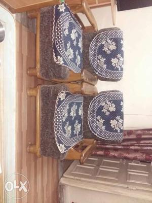 Two Brown Wooden Framed With Blue Floral Cushioned Armchairs