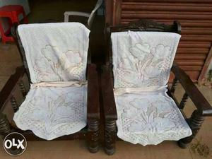Two Gray Floral Padded Brown Wooden Armchairs