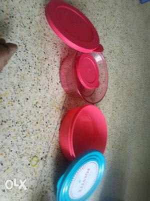 Two Round Red Plastic Containers With Lids