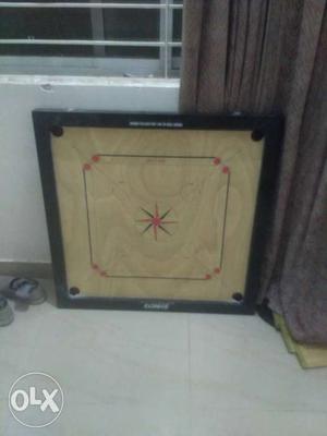 Hardly used carrom board with wooden coins and