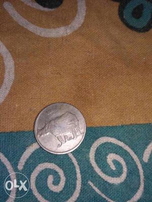 Its an old coin 25 paisa coin with gainda(hippo)