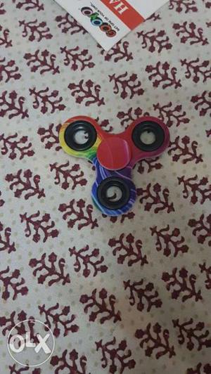 Multi coloured figdet spinner and it's box with