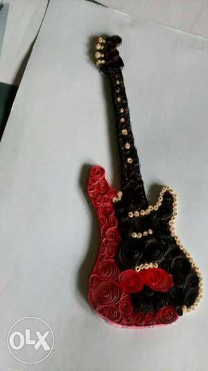 Red, Black, And Beige Electric Guitar Toy