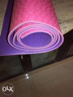 Rolled Pink And Purple Exercise Mat