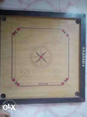Three months old carrom board with striker and