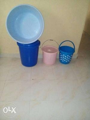 Three Blue And Pink Plastic Buckets With Blue Plastic Basin
