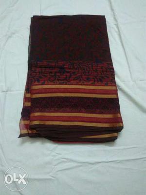 Maroon And Black Folded Textile