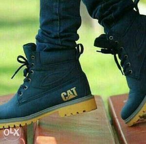 Pair Of Black CAT High Top Shoes