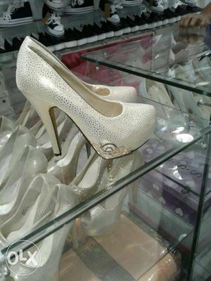 Pair Of White And Silver -colored Heeled Shoes