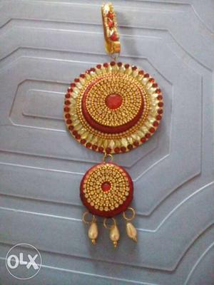 Red And Gold-colored Dangling Accessory
