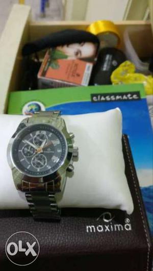 Round Silver Chronograph Watch With Silver Link Bracelet On