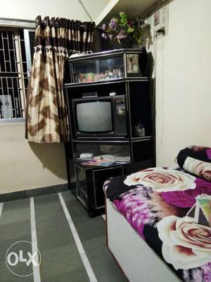 CRT Television With Black Wooden TV Hutch